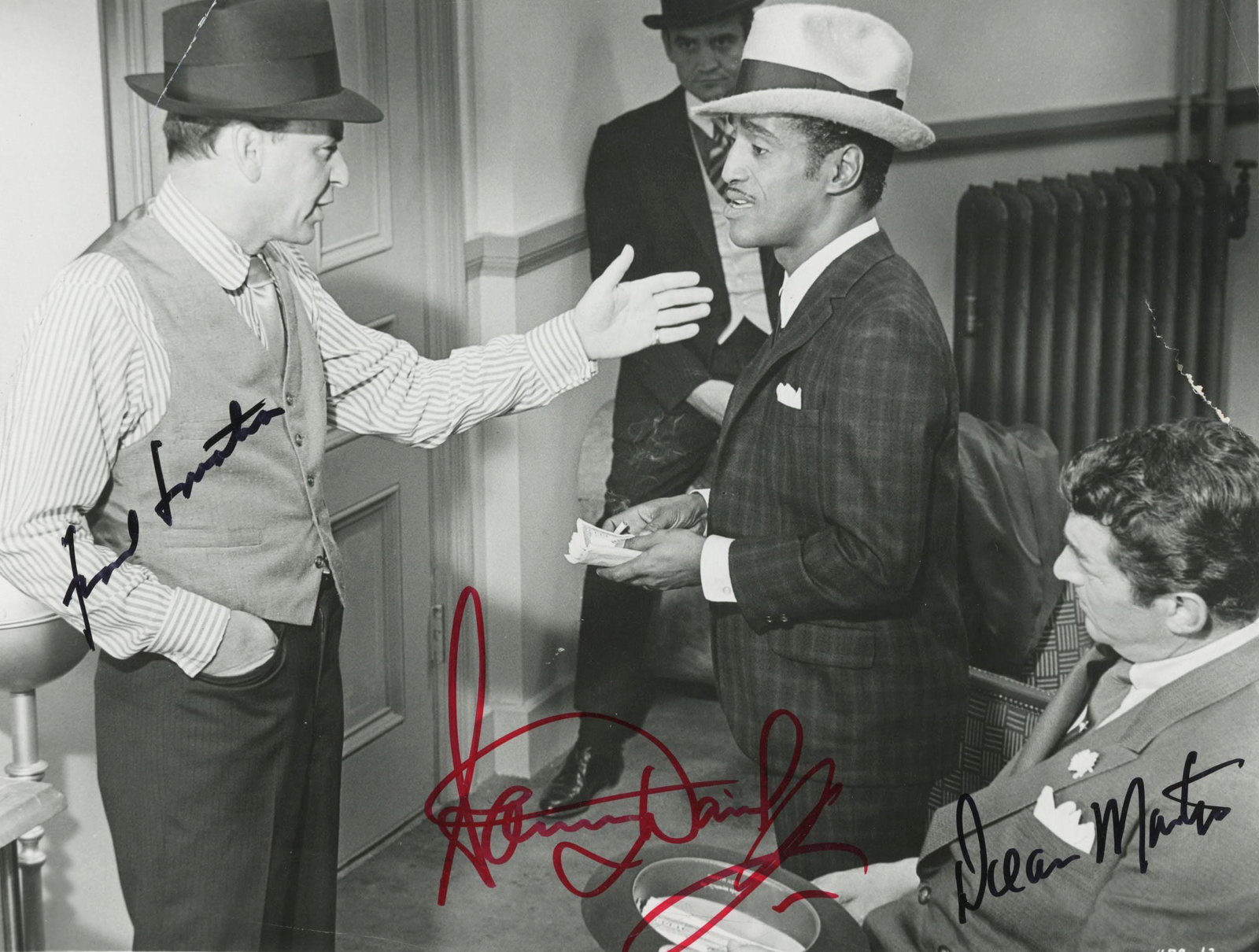 Rat Pack signed movie photo: The Rat Pack signed movie photo autographed by Frank Sinatra, Dean Martin and Sammy Davis Jr. 8x10 inches. This item is in fair condition.