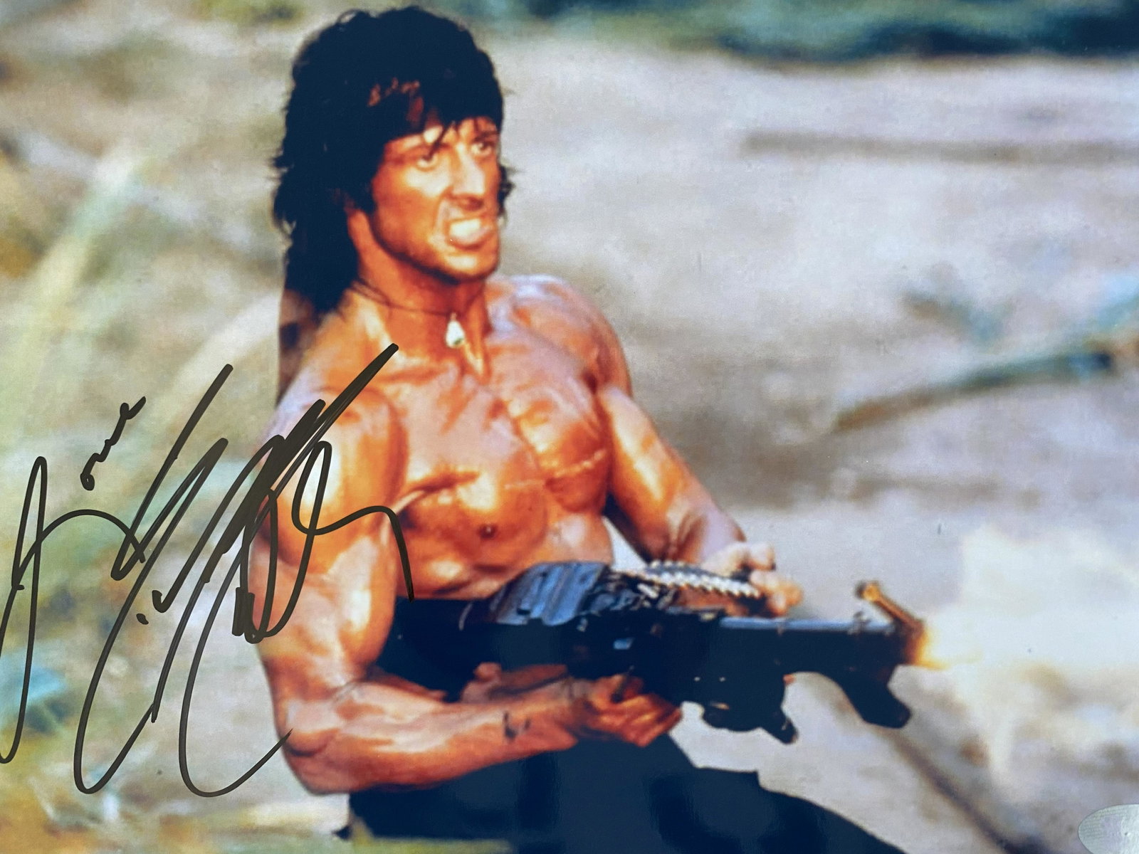 Rambo signed movie photo: Rambo signed movie photo autographed by Sylvester Stallone. 8x10 inches