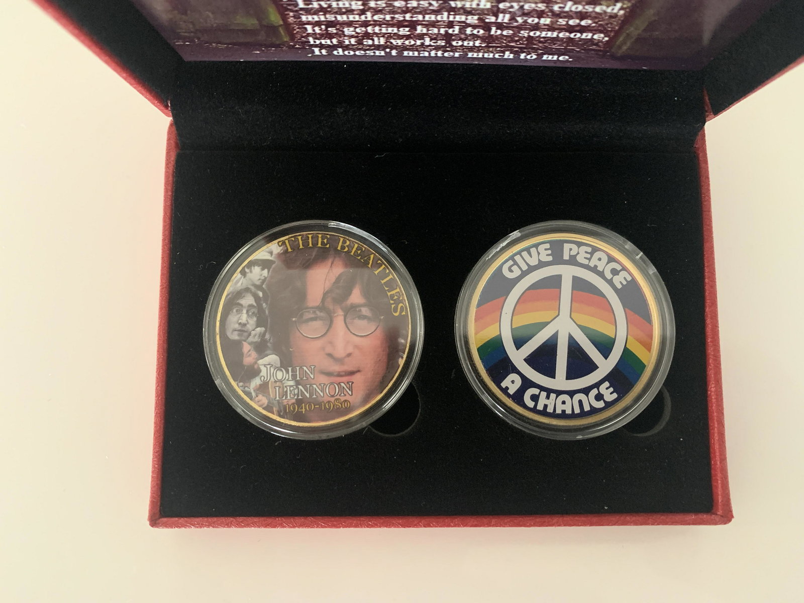 John Lennon commemorative coin set: John Lennon commemorative coin set. 3x4 inches and comes packaged in a red box. Each coin is encapsulated.