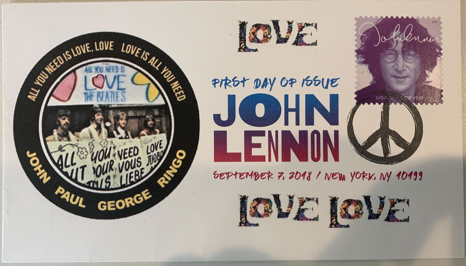 John Lennon First Day Cover: John Lennon First Day Cover. This 3 5/8 inch by 6 1/2 inch colorful FDC, with the blue gradient John Lennon stamp, that was issued on 7 September, 2018 and with the custom official USPS peace symbol c
