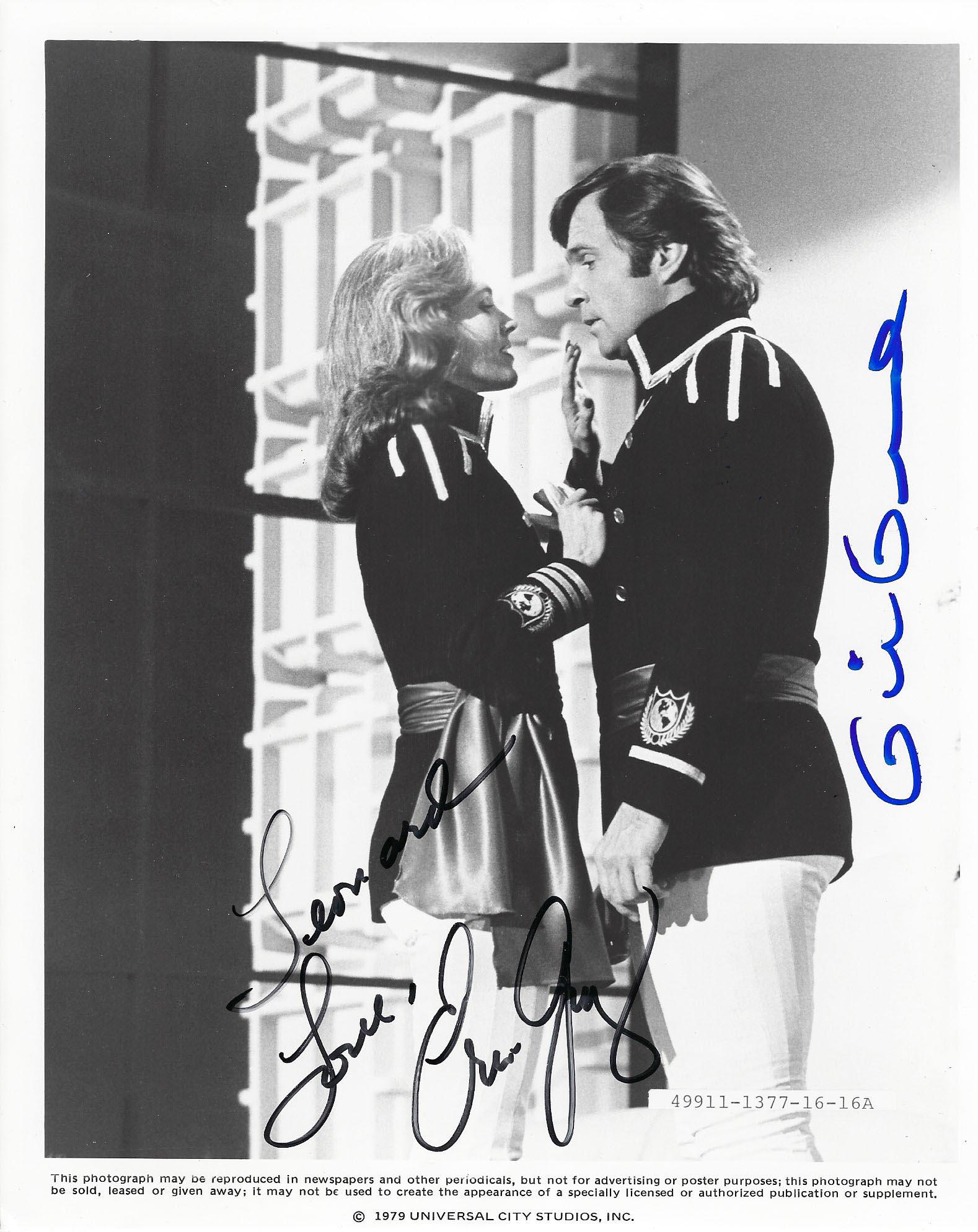 Buck Rogers in the 21st Century signed movie photo: Buck Rogers in the 21st Century signed movie photo autographed by Erin Gray and Gil Gerard. 8x10 inches