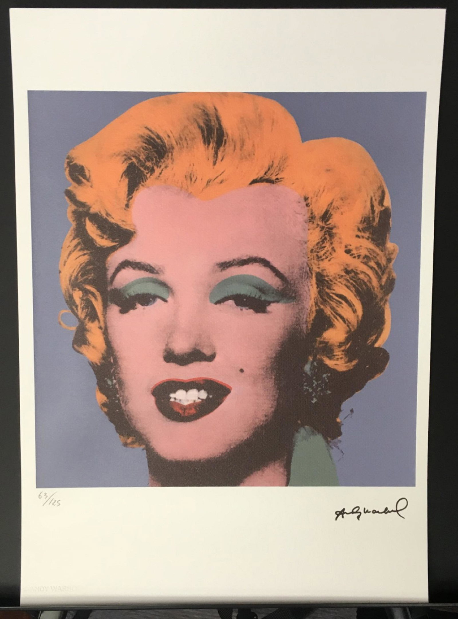 Andy Warhol Marilyn Monroe LE Lithograph: Limited edition 63 of 125 Marilyn Monroe Lithograph with Andy Warhol dry stamped (embossed) in the left corner of the paper with a black stamped signature in the right. Also, including a blue stamped 