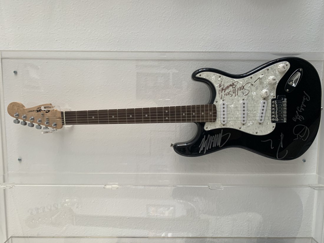 Stevie Ray Vaughn Final Concert Signed Guitar: \\\"Stevie Ray Vaughn Final Concert Signed Guitar autographed by Stevie Ray Vaughn, Eric Clapton, Jimmie Vaughn, Robert Cray, Buddy Guy. This is a Squier guitar signed not played by the musicians\\\"O