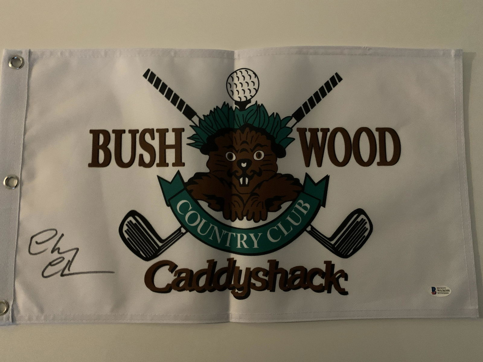 Caddyshack signed flag: Caddyshack flag signed by Chevy Chase from Bushwood Country Club. Item is approximately 12 x 20 inches. Beckett authenticated