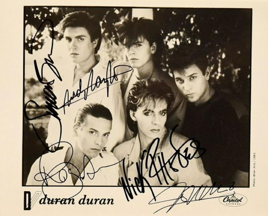 Duran Duran signed promo photo: 8 in. by 10 in. Duran Duran Black and white Capitol Records promotional photo autographed by Simon Le Bon, Nick Rhodes, Andy Taylor, John Taylor and Roger Taylor.