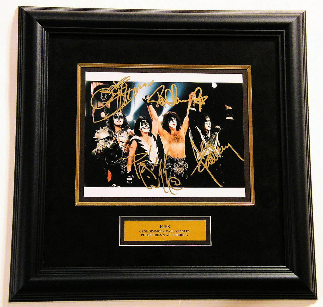 Framed Kiss signed photo: Framed 8x10 Kiss photo. 18 1/2 x 18 1/2 Inch Black Frame with Bronze Plate & UV Glass and Black Suede Matting. Plate Reads: Kiss â€“ Gene Simmons, Paul Stanley, Ace Frehley, and Peter Criss. Sign