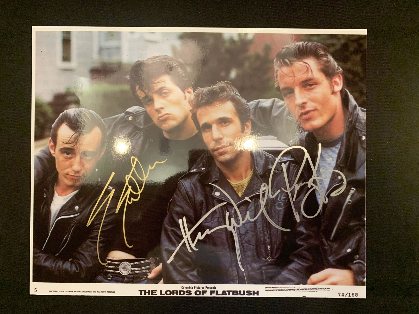 The Lords of Flatbush cast signed lobby card: The Lords of Flatbush cast signed lobby card autographed by Sylvester Stallone, Henry Winkler and Perry King
