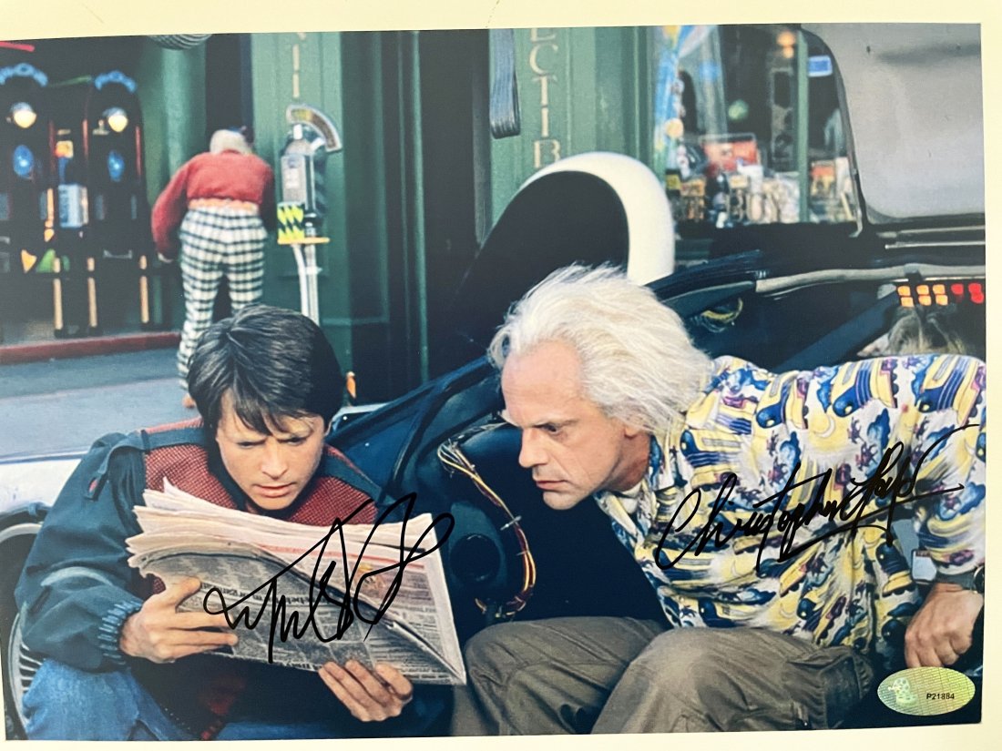 Back To The Future cast signed movie photo: Back To The Future cast signed movie photo. Autographed by Michael J. Fox and Christopher Lloyd. 8 x 10 inches. In this 1980s sci-fi classic, small-town California teen Marty McFly (Michael J. Fox) is