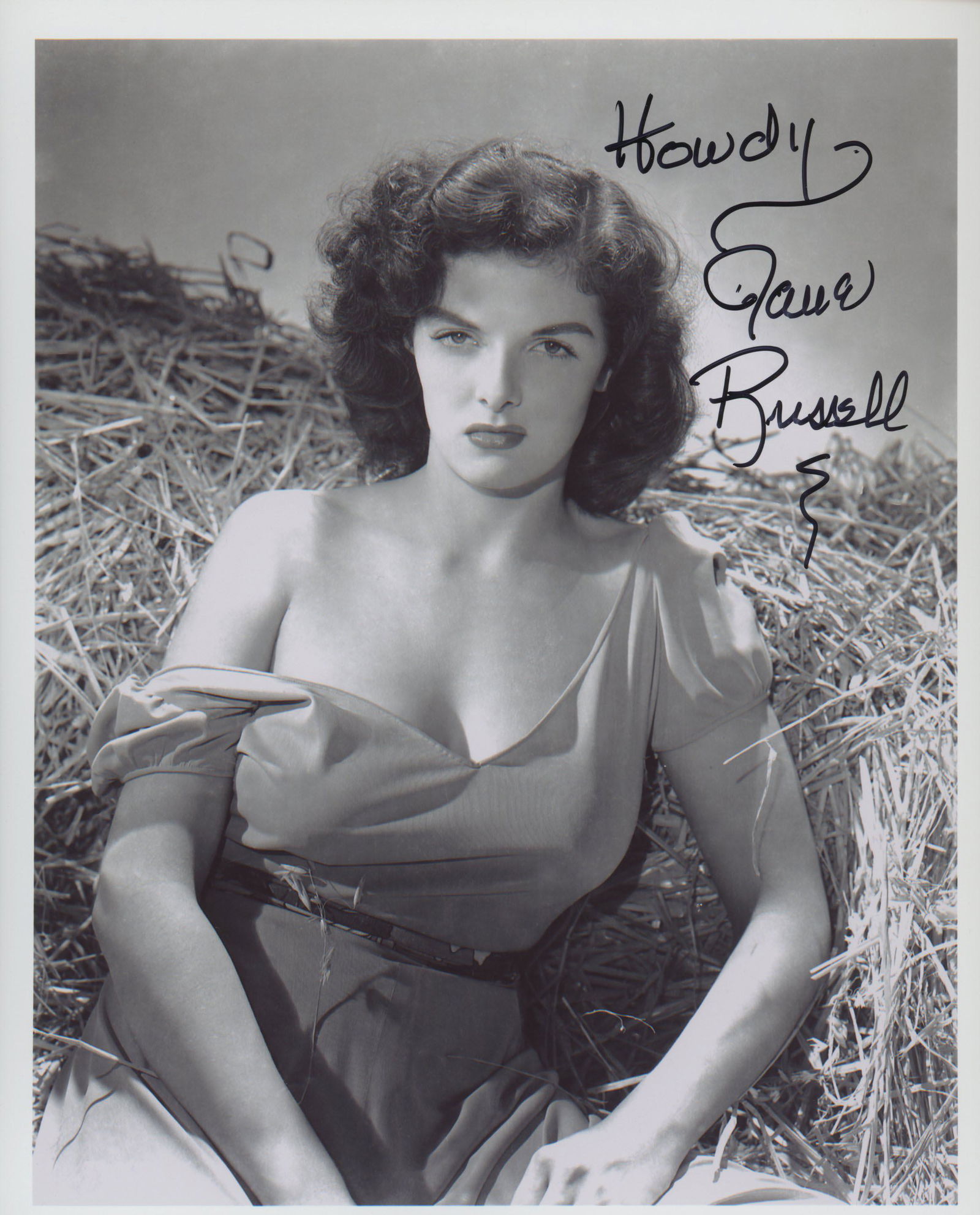 Jane Russell signed "The Outlaw" movie photo: The Outlaw 8x10 movie photo autographed by Jane Russell.