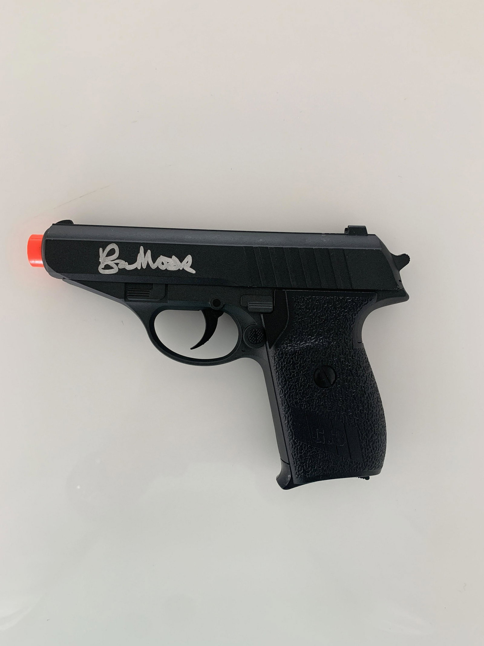 James Bond Signed Replica Gun: Roger Moore James Bond signed Airsoft gun. 4x6 inches