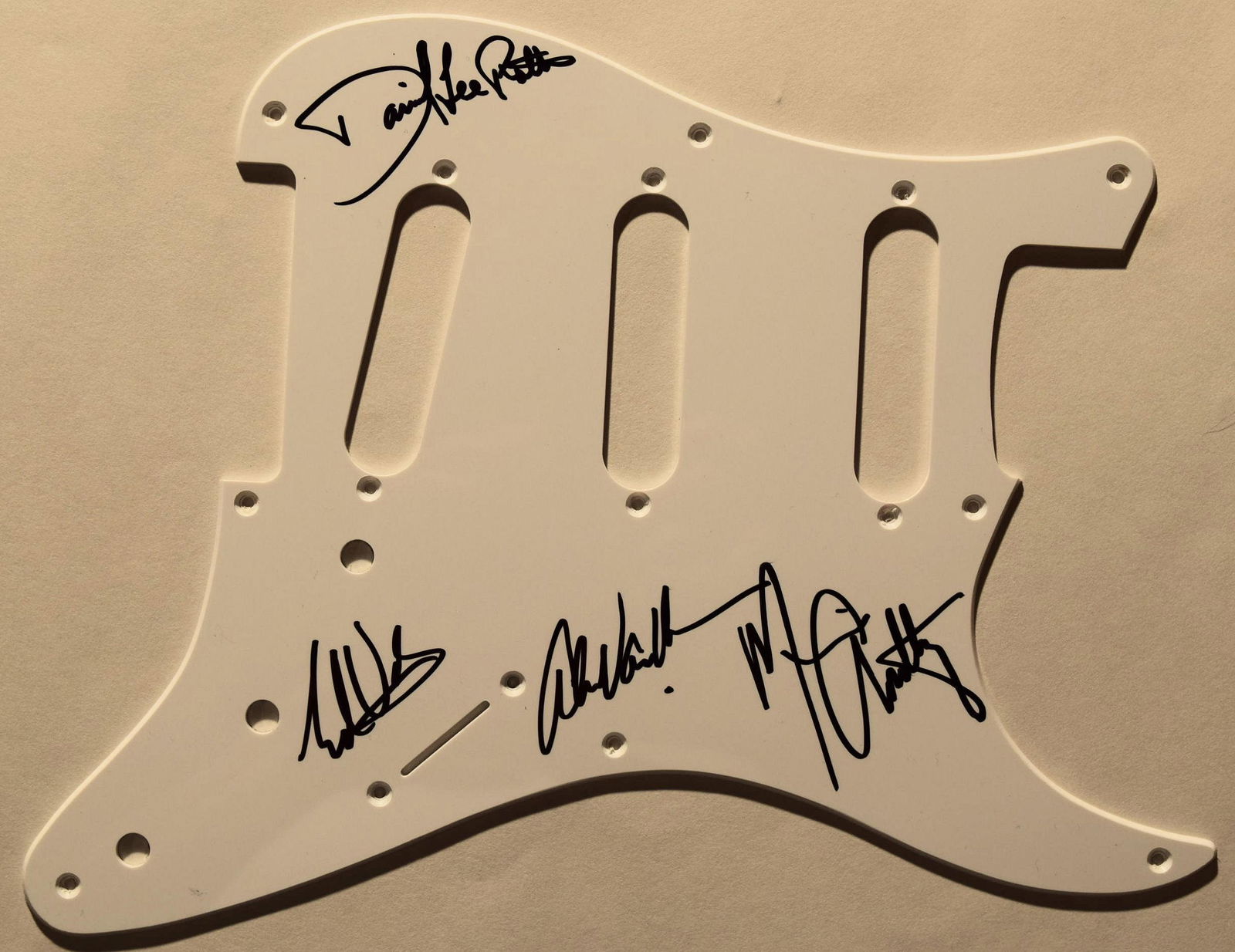 Van Halen signed pickguard: Van Halen pickguard signed by Eddie Van Halen, Alex Van Halen, Michael Anthony, and David Lee Roth.