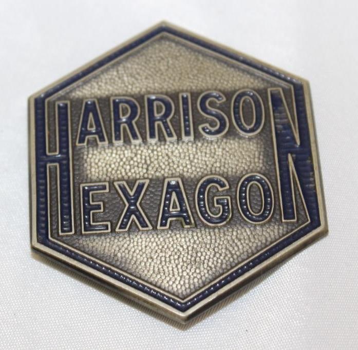 1920's Harrison Hexagon Radiator Emblem Badge: 2" x 2.25"