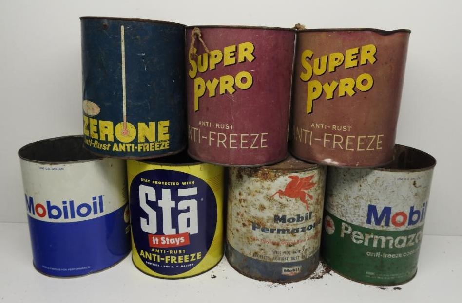 Group of Seven Assorted Gallon Oil and Anti-Freeze Cans: Includes Pyro, Mobil, and others, all in fair to poor condition with some missing lids
