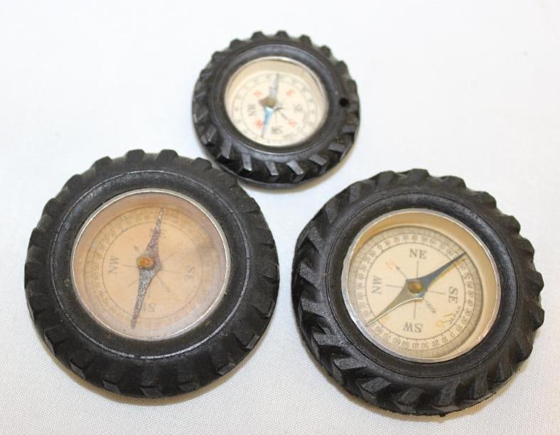 Group of 3 Tire Advertising Compasses: largest 2" diameter