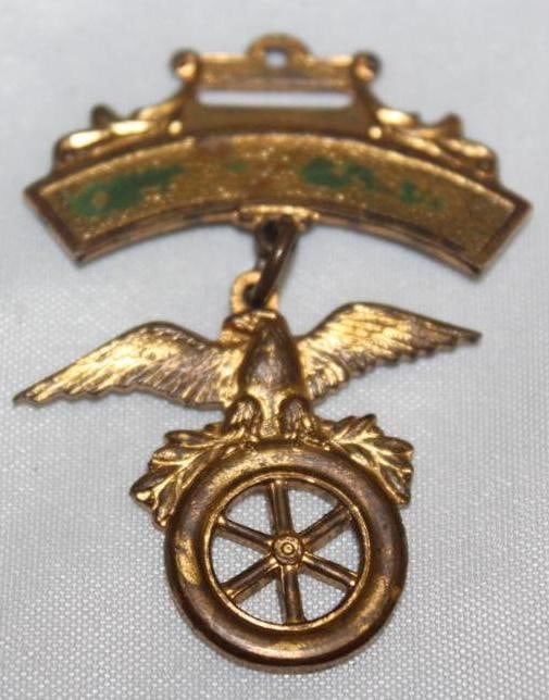 Eagle on Automobile Wheel Figural Pin Badge: 2" x 1.5"