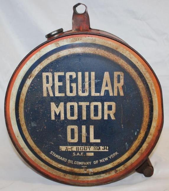 Socony Regular Motor Oil 5 Gallon Rocker Oil Can: The front of the can has rust staining and discoloration. The reverse has some remnants of a Socony Shield Decal covering the original can. The reverse also has some small areas of paint loss and stai