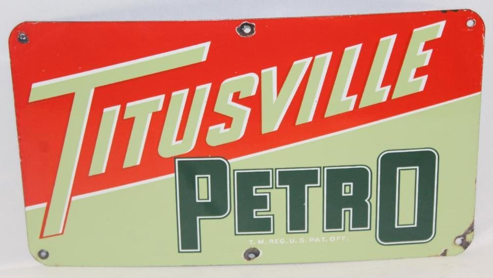 Titusville Petro Porcelain Pump Plate Sign: It has excellent colors and gloss throughout. There are small chips around a few of the mounting holes. It is graded 8.9 and measures 9.5" x 16.5"
