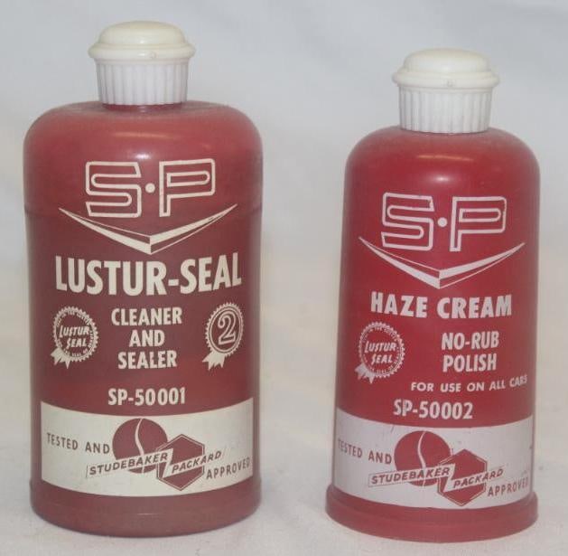 Group of 2 Studebaker Advertising Bottles; Haze Cream & Lustur Seal: 8 & 12 oz; The larger one is slightly faded