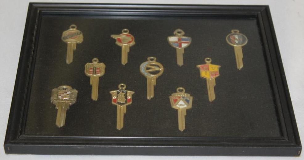 Group of 10 Uncut Automobile Keys with Frame: Ford, Lincoln, Dodge, Chrysler, Cadillac, Mercury, Buick, Studebaker, DeSoto; 10.75" x 9.25"