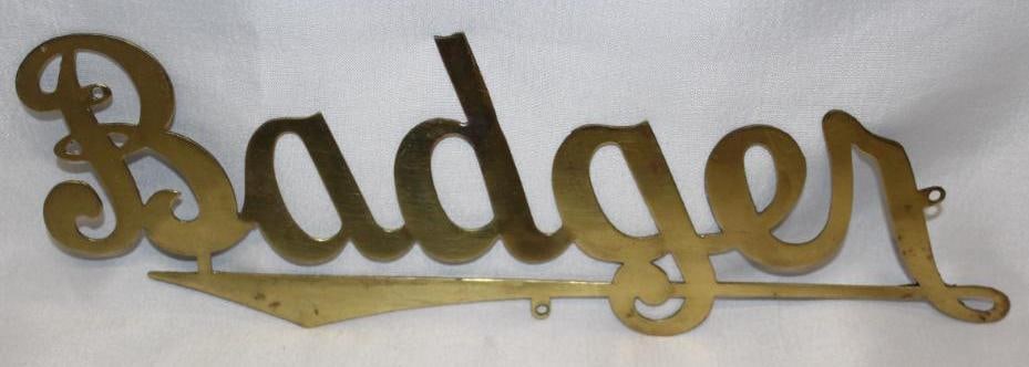 1908-1912 Brass Badger Radiator Emblem Script: 9.25" x 3", there is a small break between the B and the A