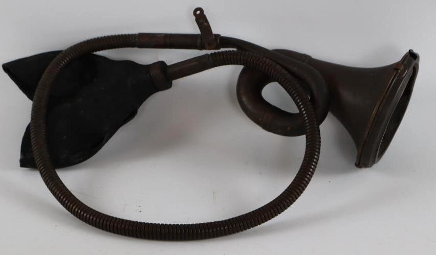 Brass Single Twist Automobile Bulb Horn: The bulb is dry rotted. 50" in length with 5" Diameter bell. The outer screen is missing