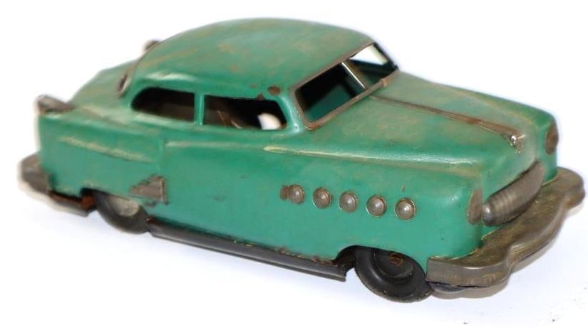 1950's Green Sedan Friction Tin Toy Car from Japan: appears to be coated in wax, 8.5"