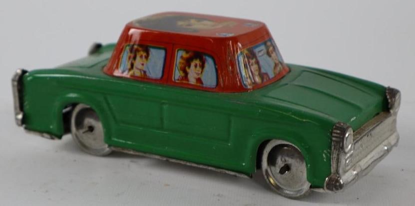 1950's -1960's Green Sedan Women Graphic Hand Driven Car Held Tin Toy Car (1 of 3)