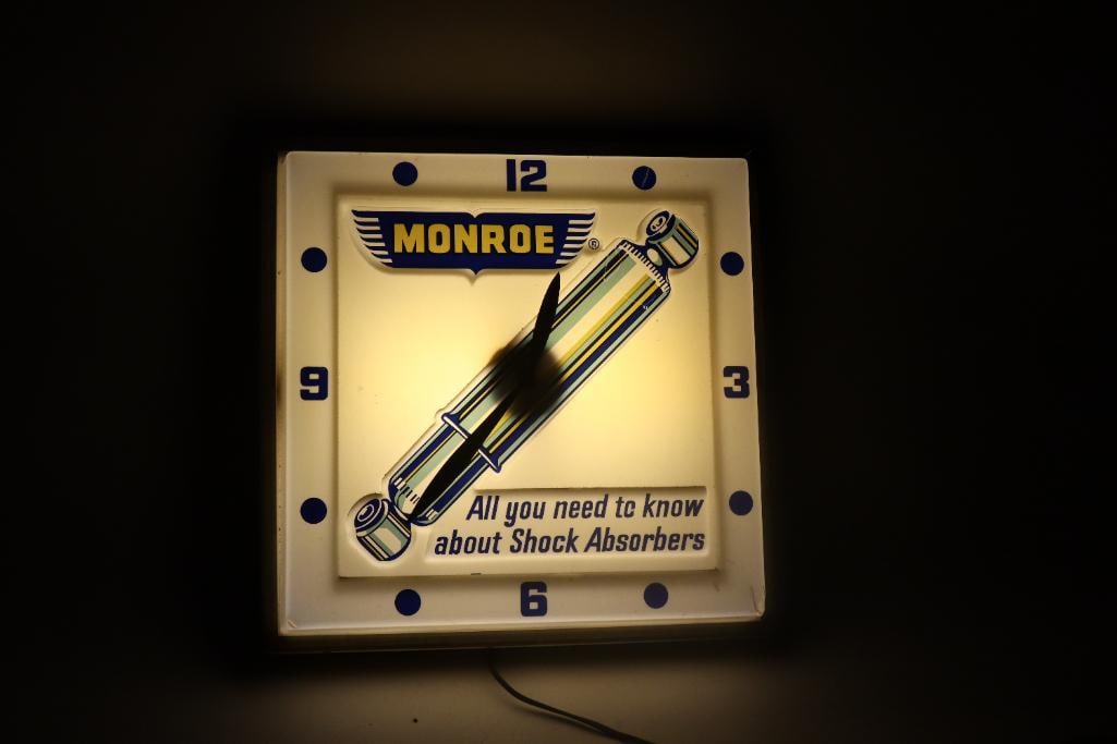 Monroe Shocks Advertising Light Up Plastic Clock: 16" x 16" x 4", lights up but clock does not run, marked Dualite