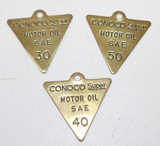 COLLECTION OF 3 CONOCO SUPER MOTOR OIL BRASS TAGS. (1 of 2)
