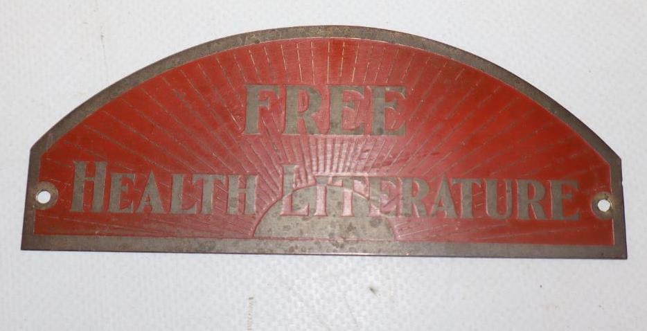 FREE HEALTH LITERATURE STAMPED BRASS REST ROOM SIGN.: 5" X 2". 1930'S STAMPED BRASS SIGN SHOWING FREE HEALTH LITERATURE. CONDITION: VERY GOOD COLOR THROUGHOUT WITH MNOR SURFACE WEAR THAT SHOULD CLEAN IF DESIRED. OUTER EDGES AND MOUNTING HOLES ARE IN EXCE