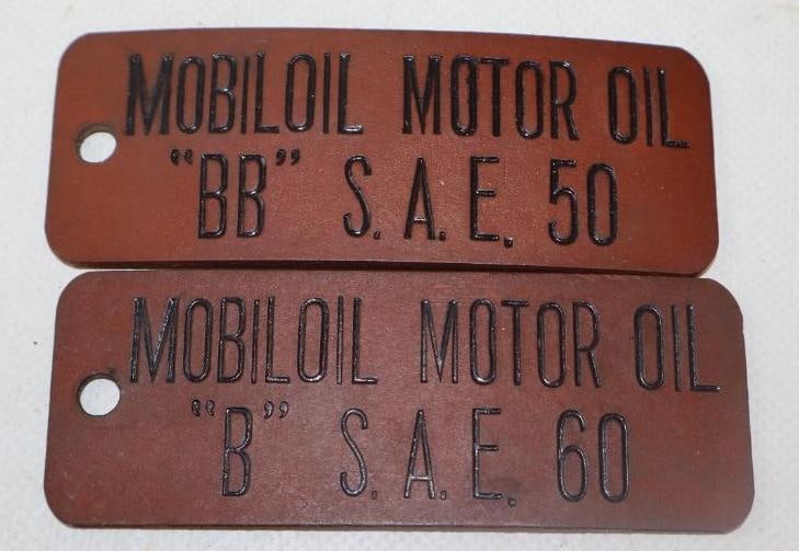 COLLECTION OF 2: MOBIL MOTOR OILS BARREL TAGS.: 4" X 1.5" EACH. 1930'S MOTOR OIL BARREL TAGS FOR MOBILOIL SHOWING STAMPED LETTERING ON EACH. CONDITION: EXCELLENT ORIGINAL CONDITION WITH LIGHT SURFACE AND AGE WEAR WITH NO NOTABLE DAMAGE.