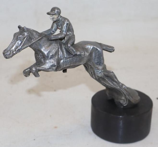 Horse and Jockey Radiator Mascot Hood Ornament: 8" x 3" x 6.50" mounted to lead base, the tail has been repaired and horse and jockey have broken legs