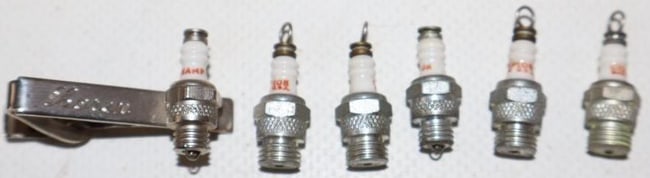 Group of 6 Mini Champion Spark Plug Charms And Tie Tac: largest is 1.25" x .75" x .50"