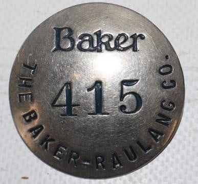 The Baker - Raulang Motor Company Employee Pin Back Badge: 1.50" diameter