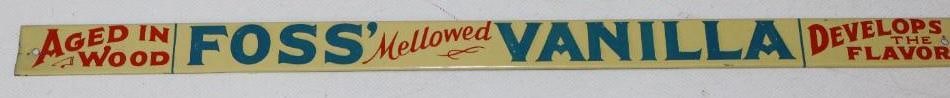 Foss' Mellowed Vanilla Aged in Wood Develops the Flavor Embossed Metal Strip Sign: In great condition with light wear and scratching. Is marked The Donaldson Sign Co. Covington NY. 17.25" x 1"