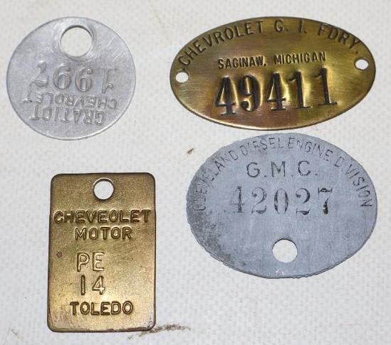 Group of 4 Different Chevrolet And GMC Identification Tags: largest is 2" x 1.25"