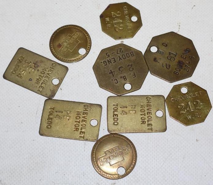 Group of 9 Brass Chevrolet And Fisher Body ID Tags: largest is 1" x 1.50"