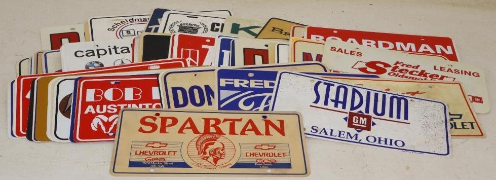 Group of 60 Plastic Dealership Booster Advertisement Plates: 12" x 6" each