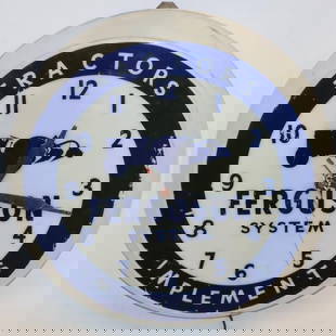 Ford Ferguson Tractors and Implements Light Up Clock: This clock lights up and runs. It retains its original Dualite label on the can. The bottom edge of the plastic surround has a crack and a chip, and the face shows some slight wear and scratches.