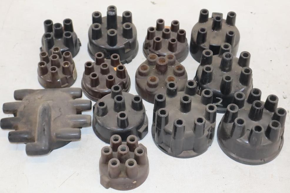 Group of 13 Early Automobile Distributor Caps: largest 5" x 4.5" x 1.5"