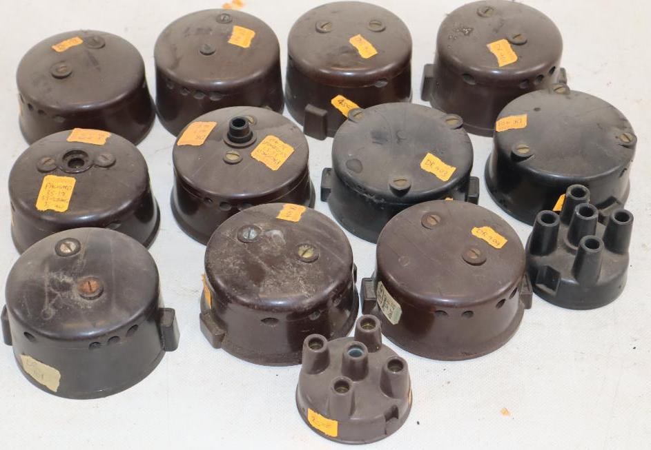 Group of 13 Early Automobile Distributor Caps: largest 3.75" x 3.5" x 1.75"