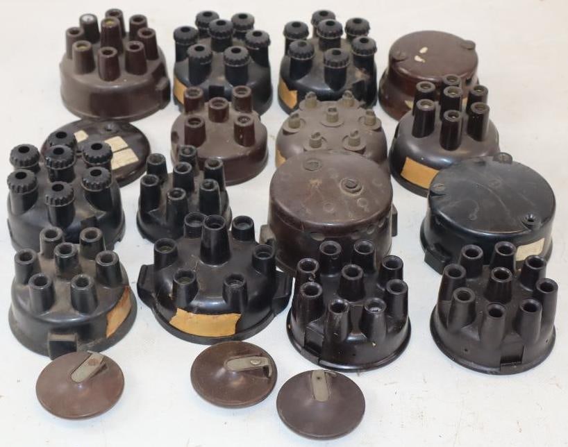 Group of 19 Early Automobile Distributor Caps and Parts: largest 4" x 3.5" x 2"