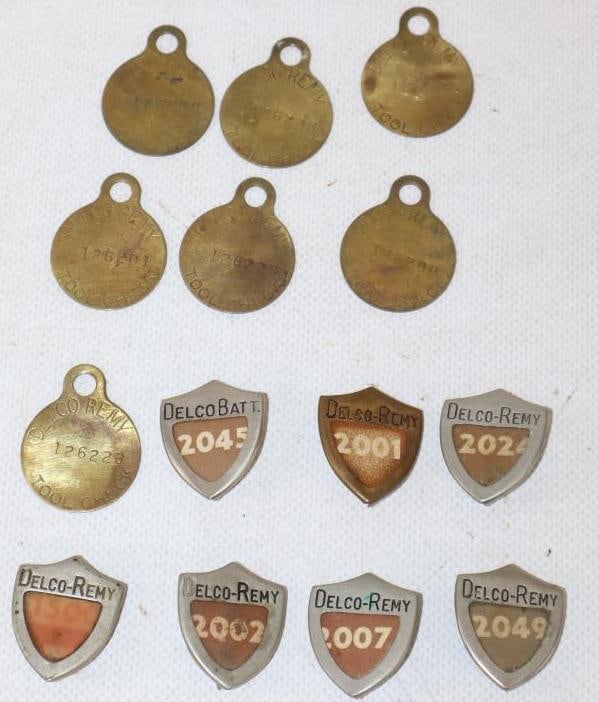 Group of 13 Delco-Remy Pin Back Badges and Brass Tags: largest 1" x 1.25"