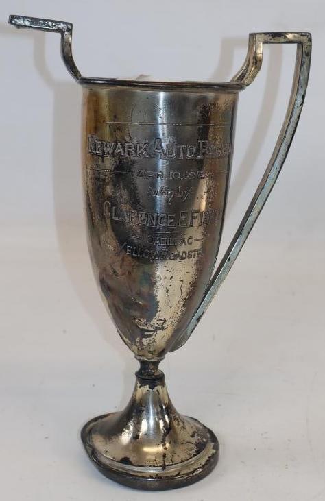 1915 Newark Auto Pageant Cadillac Yellow Roadster Winner Trophy: Won by Clarence Fisher, one of the Fisher brothers of Fisher Bodies. Silver Trophy has many dents. 8" x 5" x12"