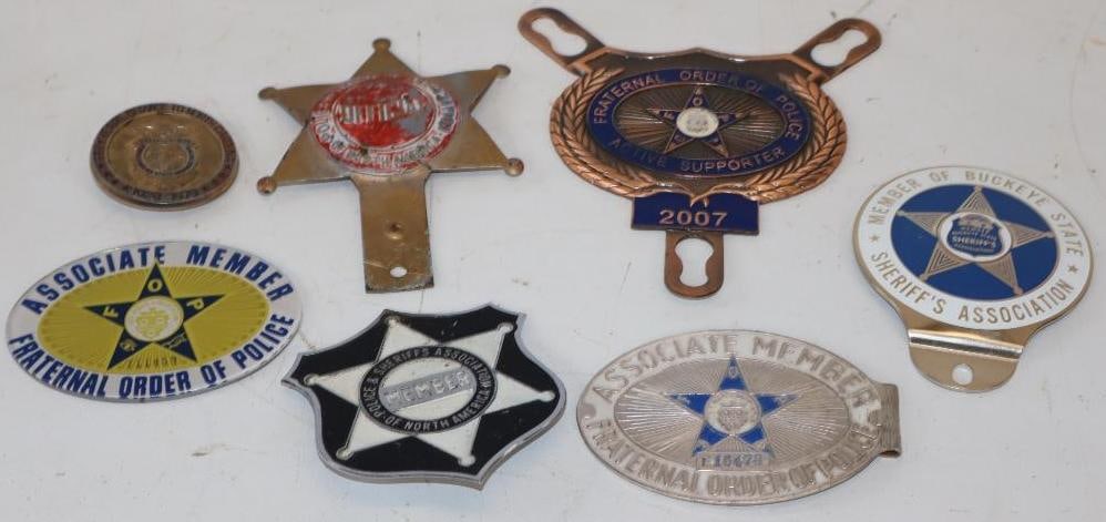 Group of 7 Sheriff and Police Related License Plate Toppers and Radiator Badges: largest 6" x 6.5"
