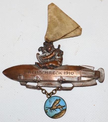 1910 Brass Airship Heuschreck with Cherub Pin Back Badge: 3.75" x 4"