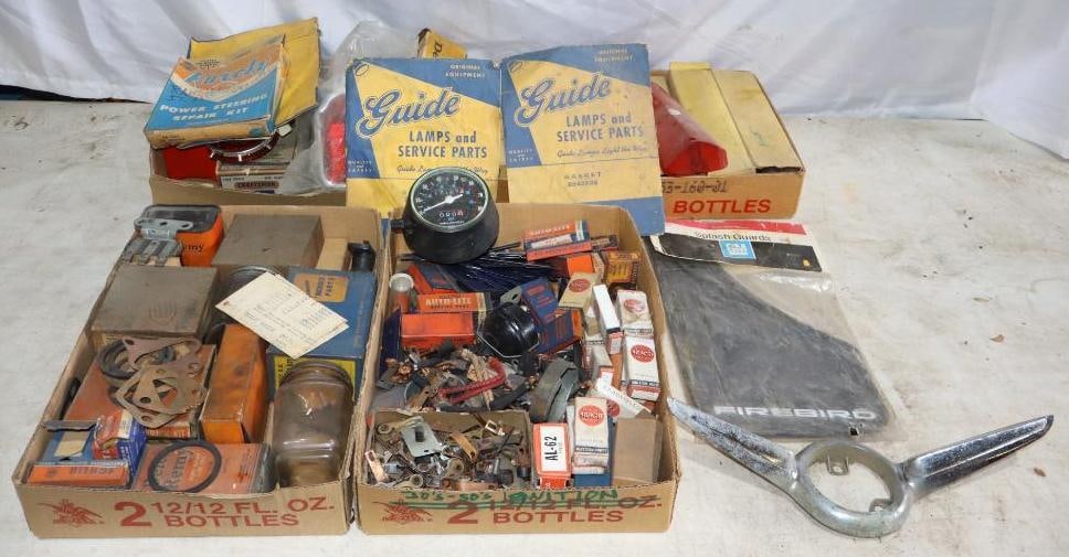 Group of Light Lenses and Ignition Parts: Light lenses in original boxes with ignition parts for various makes and models