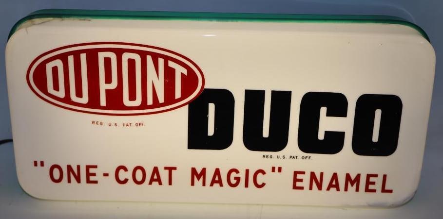 DuPont Duco Plastic Lightup Window Sign: This sign is on the original can. There are some cracks to the plastic at the top left and bottom right corners but it displays very well. It is in working condition. 20" x 9" x 5.5". Graded 8.