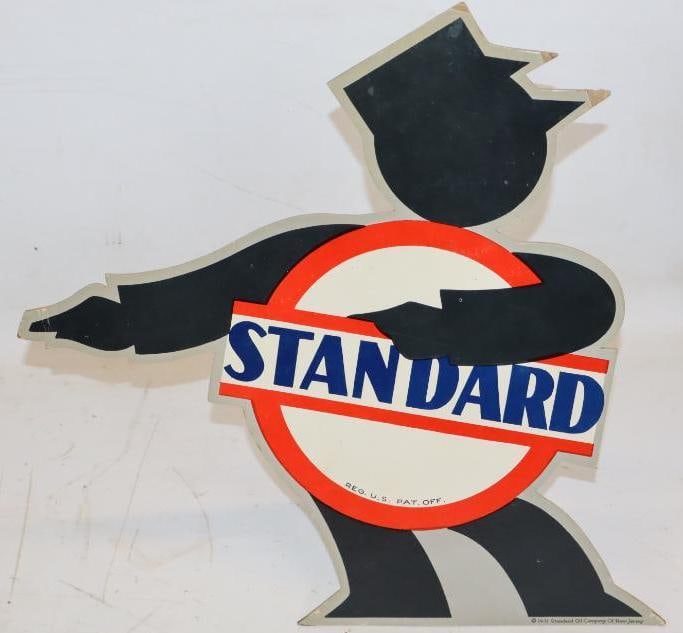 Standard Bar and Circle Service Station Attendant Countertop Easelback Display: Dated 1931, marked Standard Oil Company of NJ. It is in good condition with some slight bends at the pointed edges. 14" x 13" x 4.5". Graded 8.5.