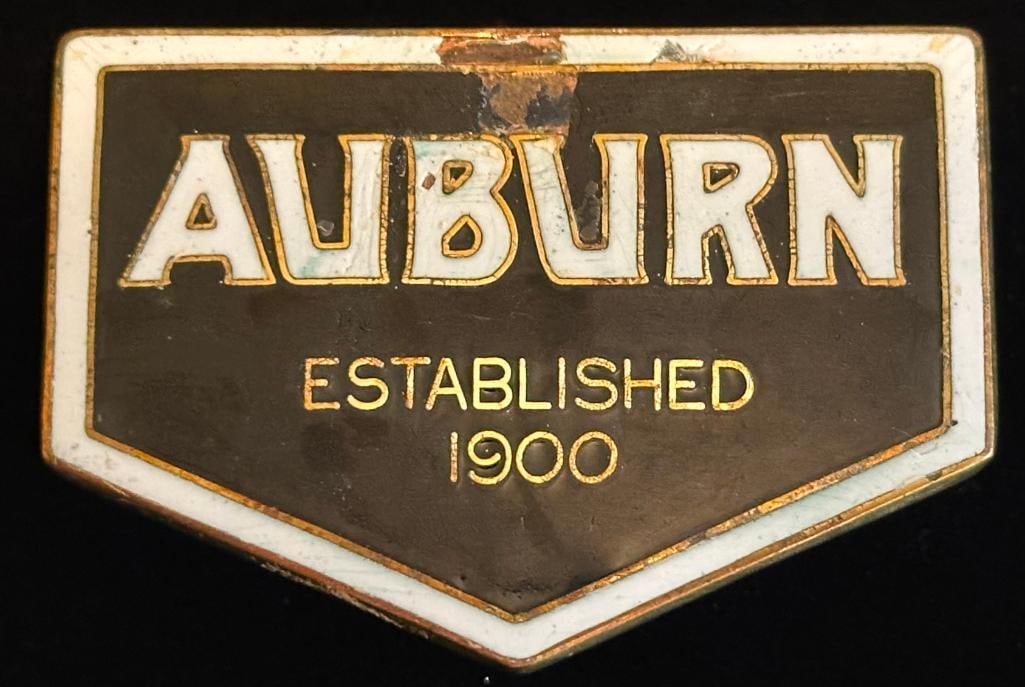 Auburn Radiator Emblem: 1924 - 1930 Auburn radiator emblem. It measures approximately 2.75" wide by 1.9" high.